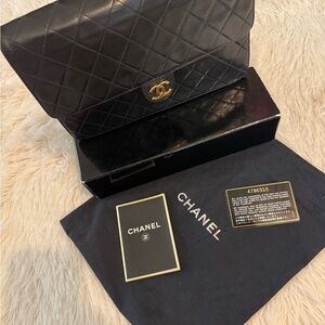 CHANEL Black Quilted Flap Bag with Gold Accent